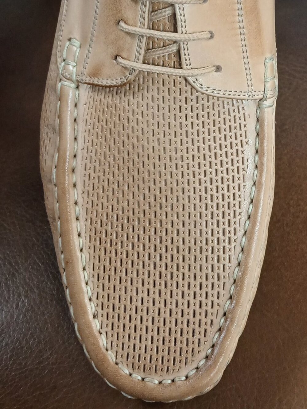 Crisp mens laced camel color loafers.